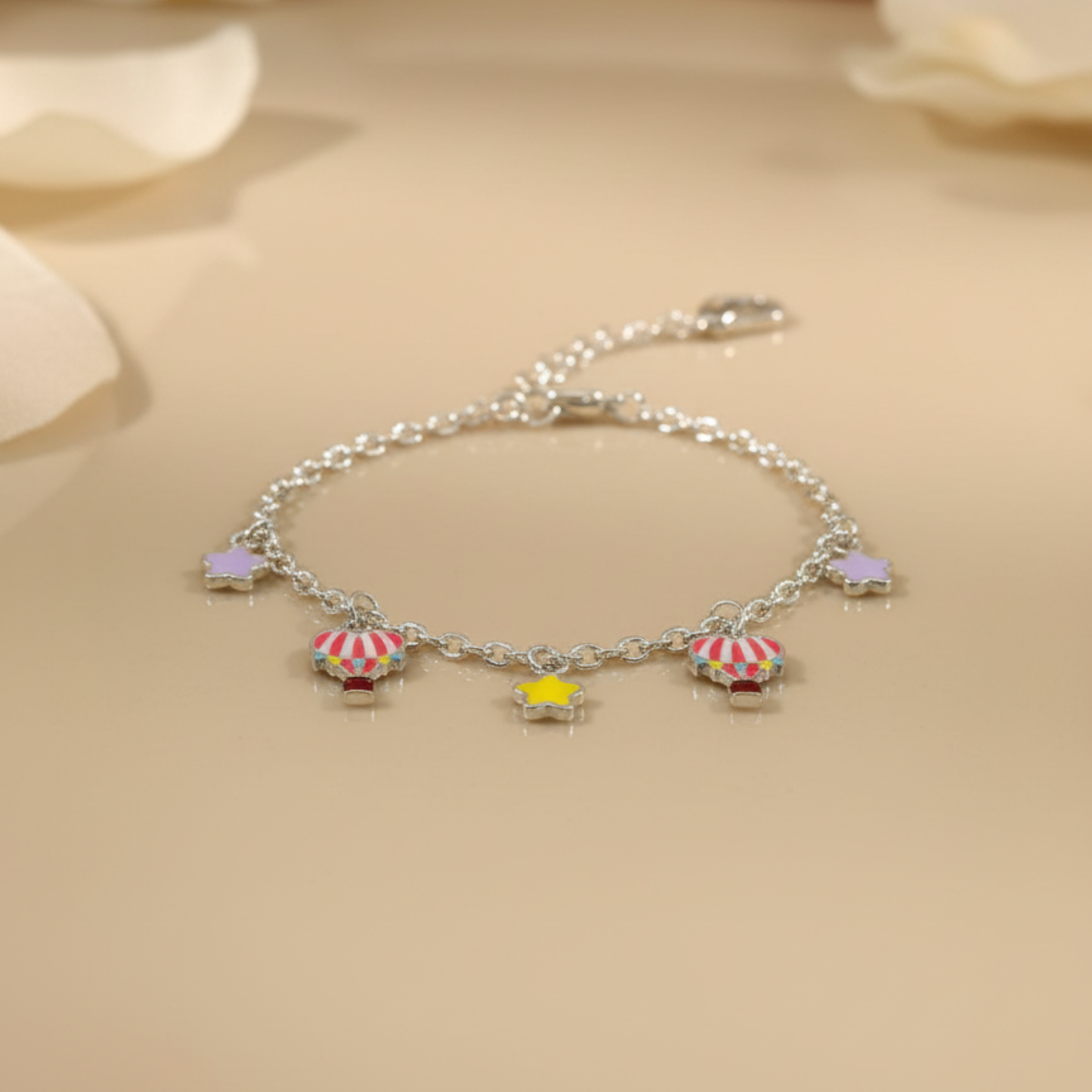 Silver bracelet with colorful charms on a beige background