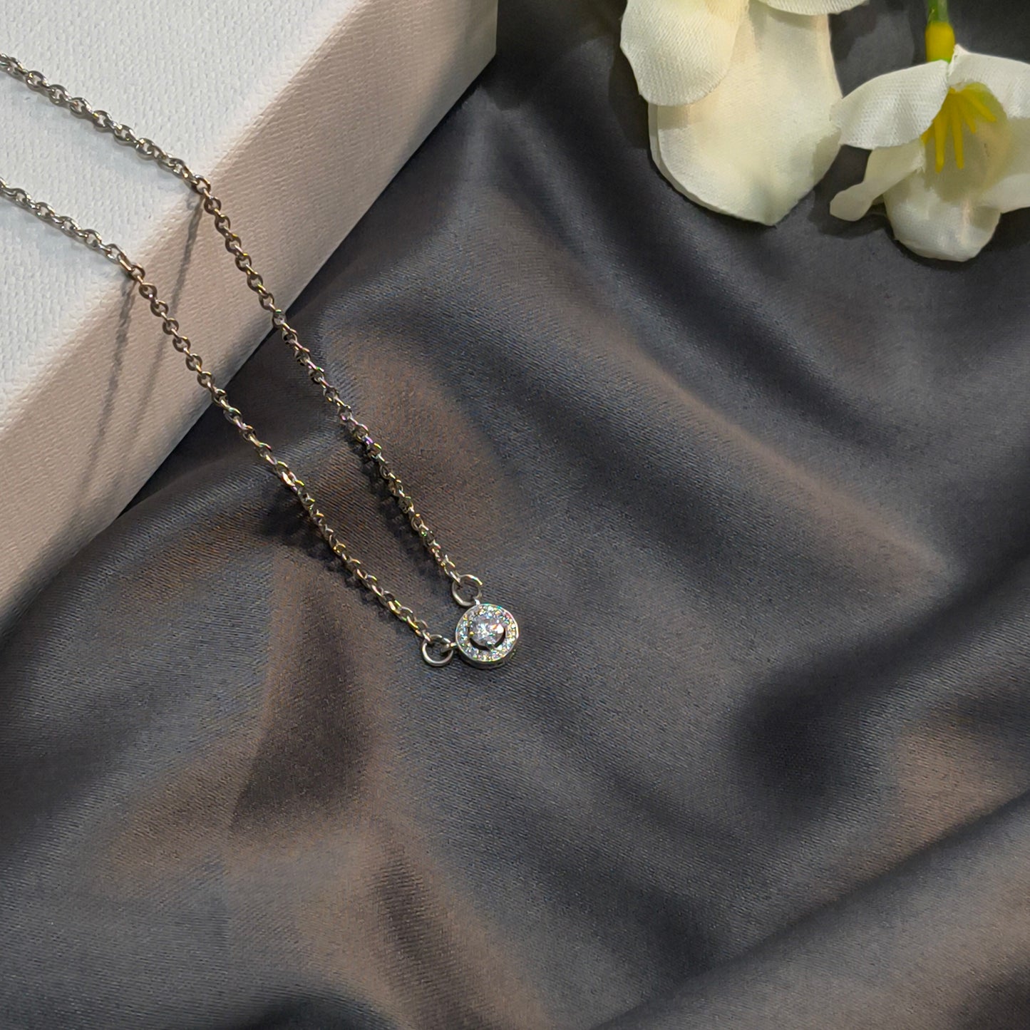 Necklace with a pendant on a dark fabric background