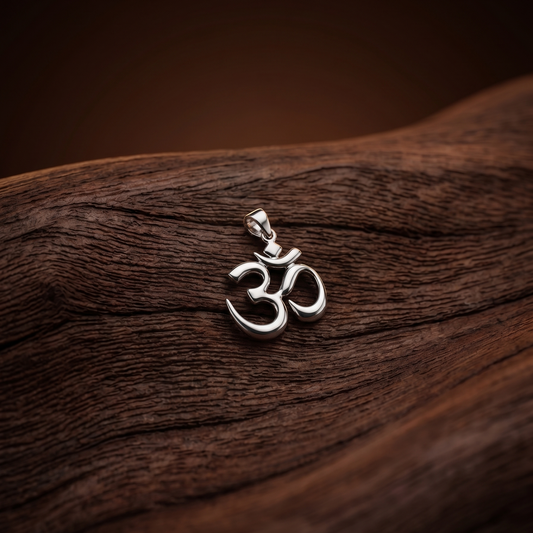 Silver Om pendant on a wooden surface