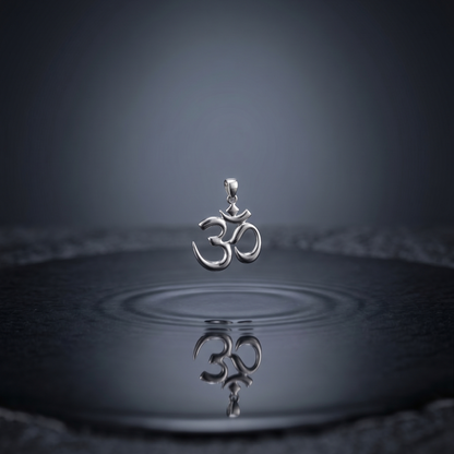 Silver pendant with Om symbol on water surface