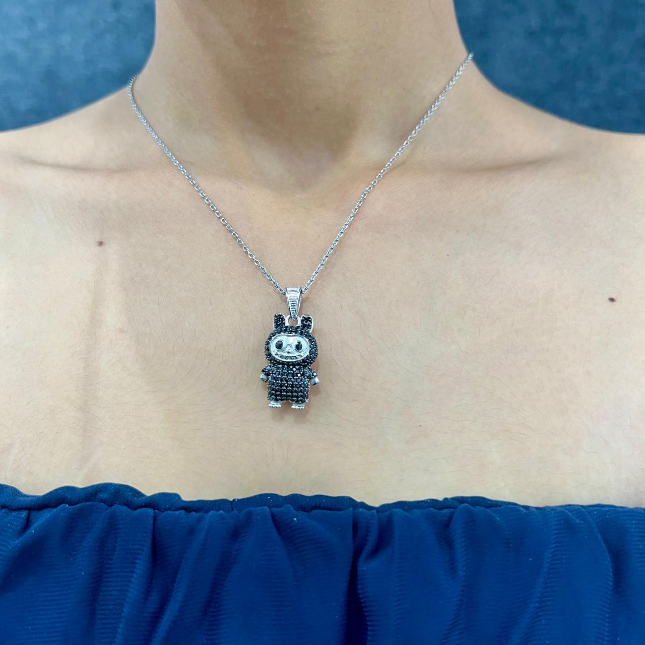 Necklace with a small pendant worn by a person against a blue background