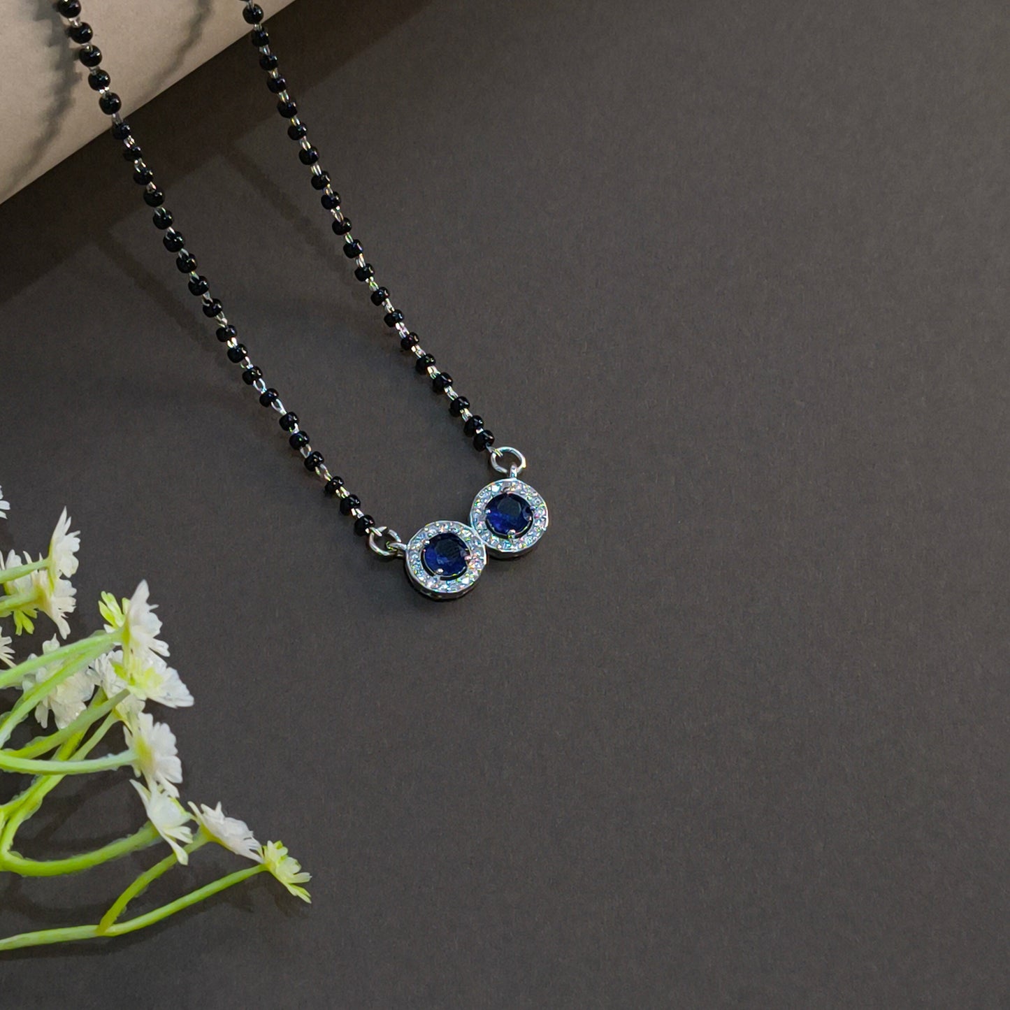 Necklace with blue gemstones on a dark background