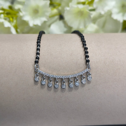 Two bracelets on a person's wrist with a floral background