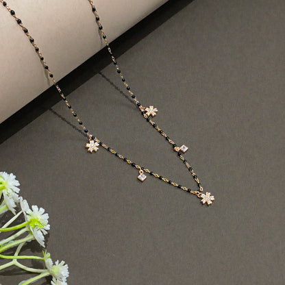 Necklace with floral pendants on a dark background