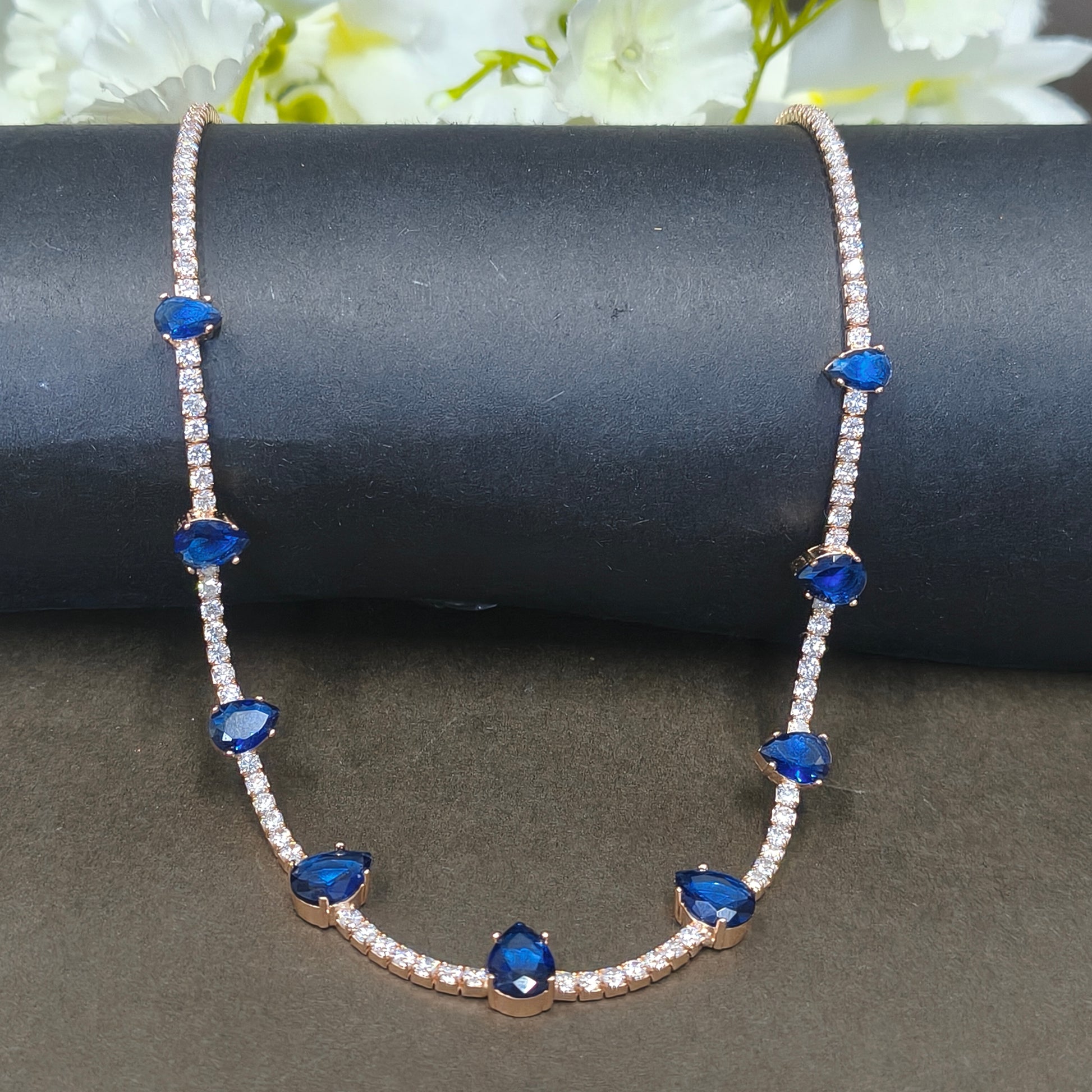 Bracelet with blue gemstones and clear stones on a dark surface