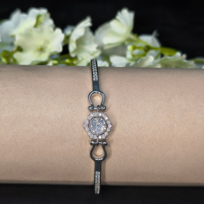 Bracelet with a diamond clasp on a mannequin arm against a floral background