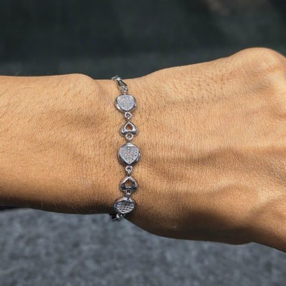 Silver bracelet on a wrist with a blurred background