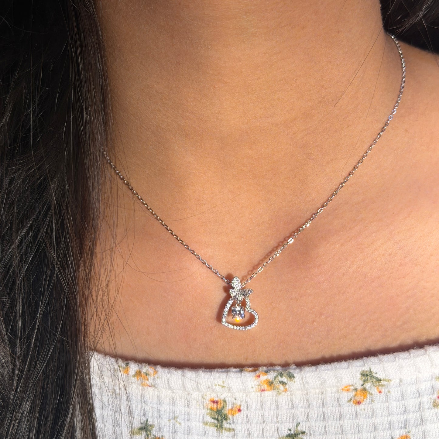 Necklace with a pendant worn by a person, close-up view.