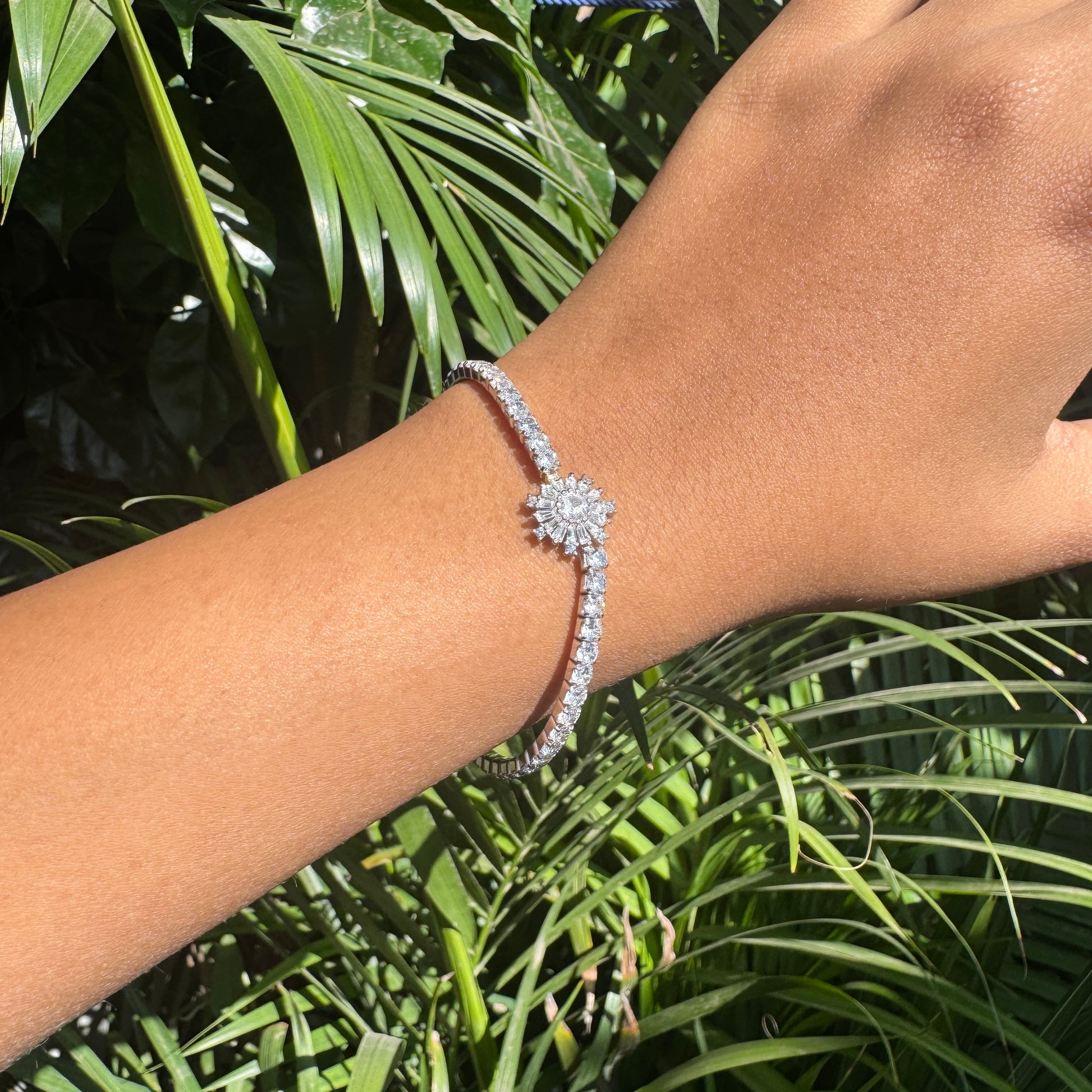Bracelet on a wrist with a green leafy background