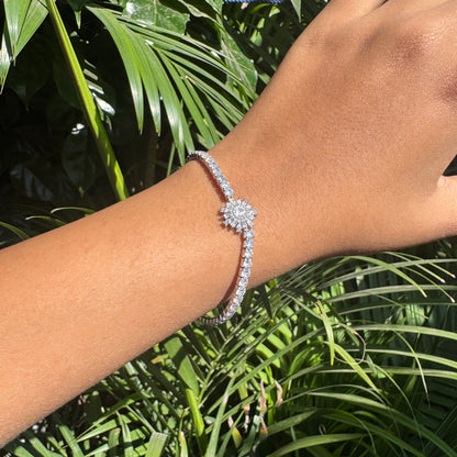 Bracelet on a wrist with a green leafy background
