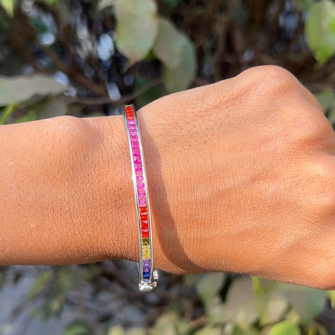 Multicolored beaded bracelet on a wrist with a natural background