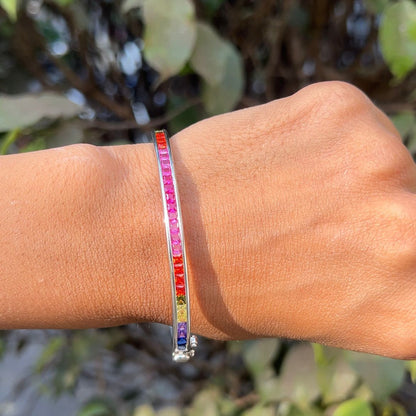 Multicolored beaded bracelet on a wrist with a natural background