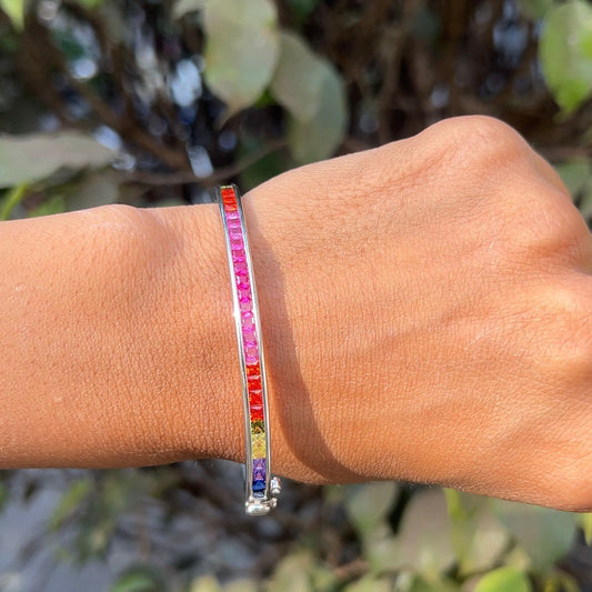 Multicolored beaded bracelet on a wrist with a natural background