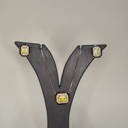 Jewelry set with earrings and a necklace featuring yellow gemstones on a gray background