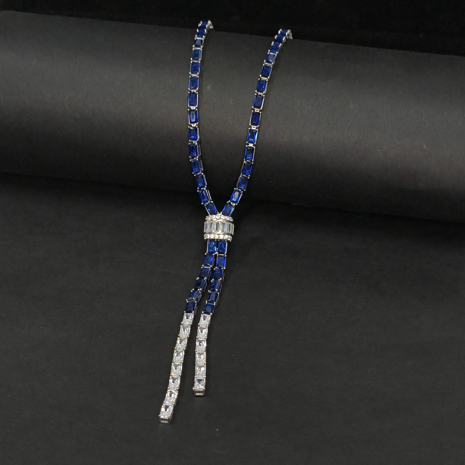Blue and silver bolo tie on a black background