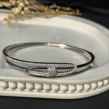 Silver bracelet with gemstones on a decorative white surface