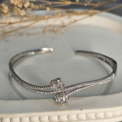 Silver bracelet with diamond accents on a white surface