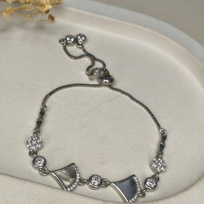 Silver bracelet with decorative elements on a light background