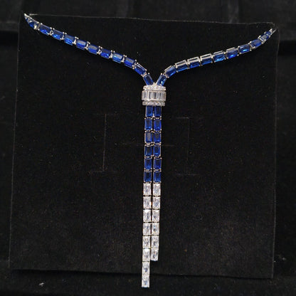 Necklace with blue and white gemstones on a black stand