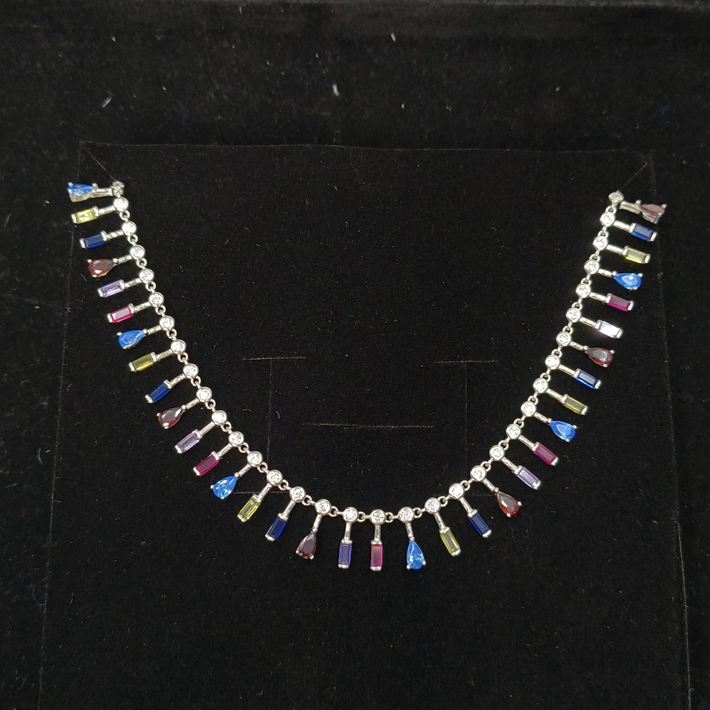 Necklace with multicolored beads on a black background