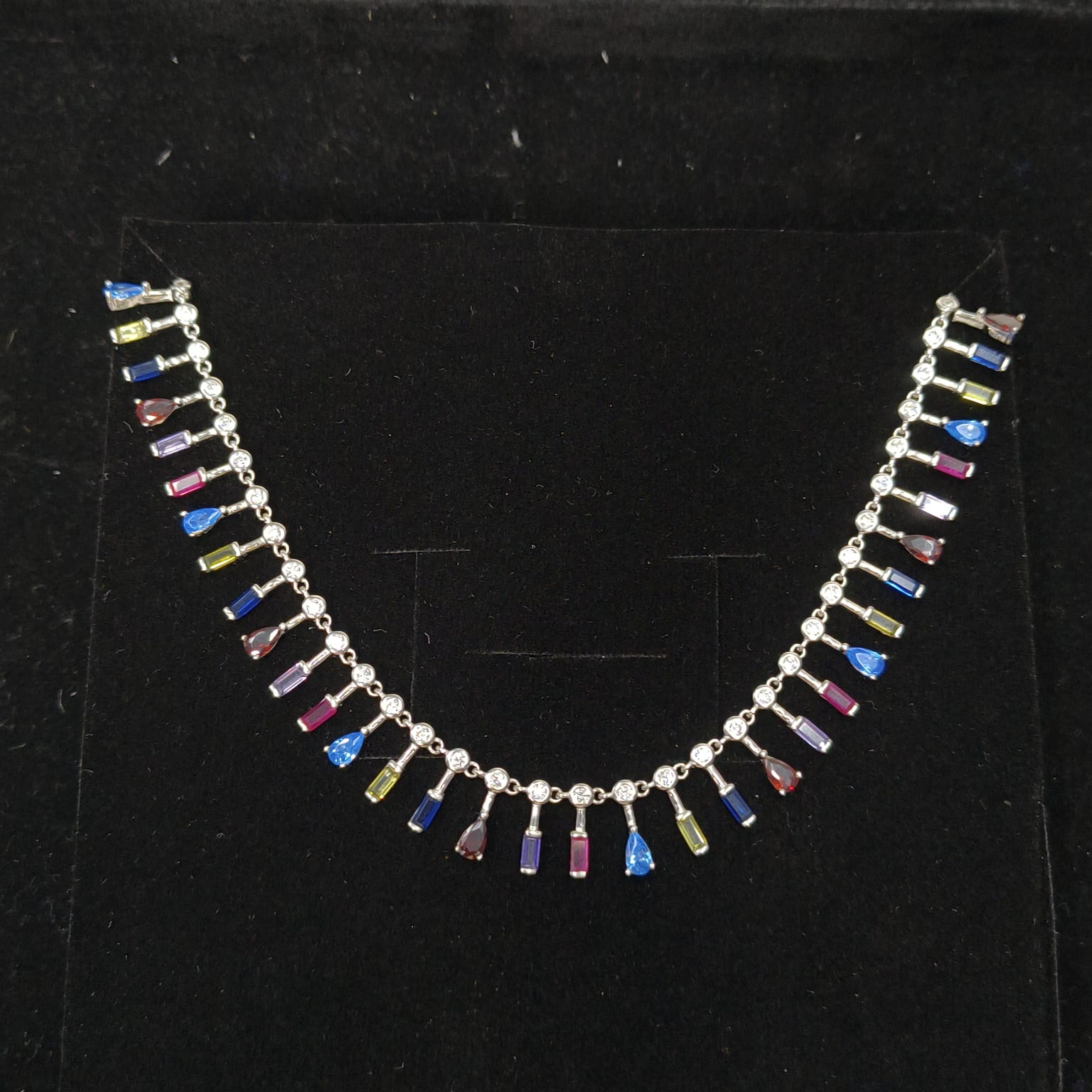 Necklace with multicolored beads on a black background