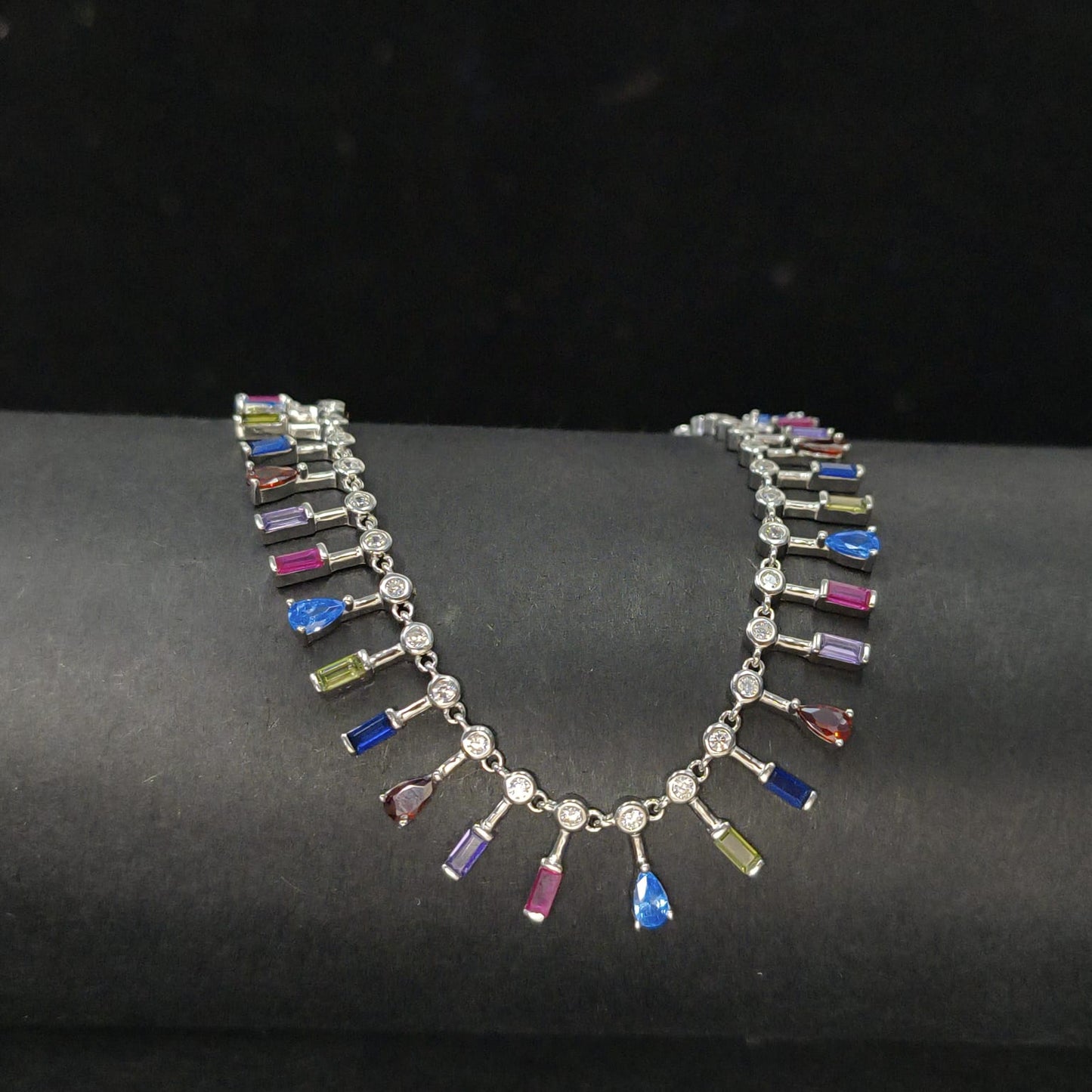 Necklace with multicolored gemstones on a dark surface
